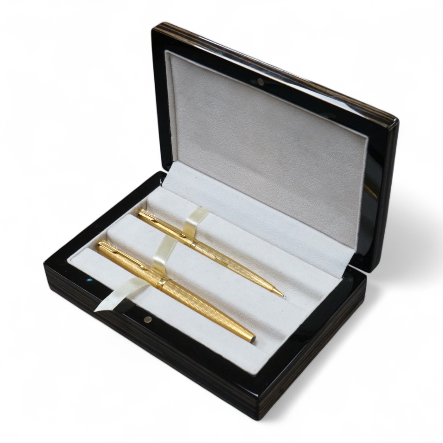 Two 18ct gold Parker pens comprising a propelling pencil and fountain pen, cased